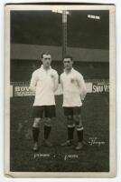 John Pearson and James Andrew Banks. Tottenham Hotspur c1921[?]. Mono real photograph postcard showing both players, full length on the pitch, in Spurs shirts, in front of the stand. W.J. Crawford of Edmonton. Slight silvering to edges otherwise in good c