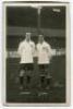 John Pearson and James Andrew Banks. Tottenham Hotspur c1921[?]. Mono real photograph postcard showing both players, full length on the pitch, in Spurs shirts, in front of the stand. W.J. Crawford of Edmonton. Slight silvering to edges otherwise in good c