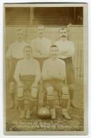 Tottenham Hotspur ‘All that was left of them. Winners of the English Cup. Tottenham Hotspurs’. Early sepia real photograph postcard depicting a group of five players, all in Spurs attire, seated and standing in rows with ball to centre on the ground, stan