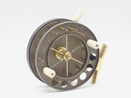 A fine Mill Tackle Co. "Millbrake" 4 ¼" centre pin reel, caged and six spoked drum with twin ivorine handles, ventilated front flange (12 holes), twin release/regulator forks, ribbed brass foot, rim mounted ivorine pressure brake lever, rear brass slidin