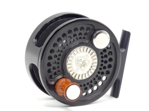 A fine Charlton Thinn-Line Elite model 8400 fly reel, right hand wind model with black anodised finish, counter-balanced rosewood handle, milled spool locking disc and rear tension adjusting wheel, as new condition, in original cloth pouch (see illustra