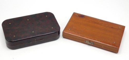 A Hardy Neroda No.1 bakelite salmon fly box, oxblood finish, interior fitted forty spring clips and holding a selection of 28 fully dressed salmon flies, including gut eyed examples and a stained pine rectangular trout fly box fitted spring clips on ivori