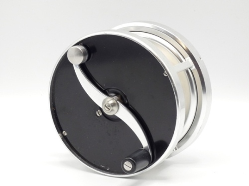 A good Saracione Mk.IV Alta 4 ¾" multiplying salmon fly reel, 2:1 ratio retrieve, left hand wind model with black anodised end plates, alloy cage, counter-balanced serpentine crank wind arm, block foot, rear sliding drum locking button and spindle mounted