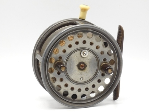 A Hardy Silex Major 4 ¼" bait casting reel, shallow cored drum with twin ebonite handles, spring latch and jewelled spindle bearing, brass foot, rim mounted ivorine casting trigger, milled tension screw and rear ivorine quadrant weight indicator, 1920's