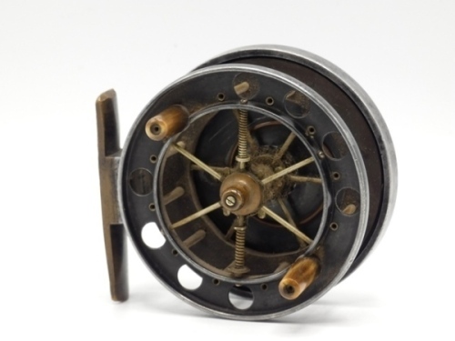 An Allcock Aerial 3" model 7950-T2 centre pin reel, caged and six spoked drum with twin tapered horn handles, ventilated front flange (eight holes), ebonite rear flange and twin release/regulator forks, brass stancheon foot, rear sliding brass optional c