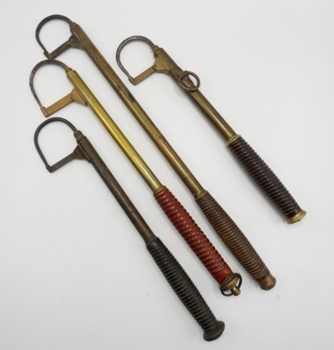 A 19th Century brass extending salmon gaff, turned treen handle, hinged point cover, Firth steel head and ring belt clip and three further brass extending salmon gaffs of similar design (4)