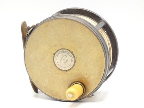 A very rare Hardy Brass Faced Perfect 4 ¼" salmon fly reel and block leather case, with the rarely seen applied nickel silver circular medallion spindle cover to front plate, domed ivorine handle, brass foot (neatly reduced), strapped rim tension screw wi