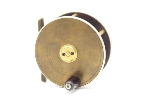 A Hardy brass and ebonite 3 ½" salmon fly reel, domed horn handle, bridge foot, twin German silver rims, quadruple cage pillars, no check, faceplate with raised two screw spindle boss and stamped enclosed oval logo, wear from normal use, circa 1895