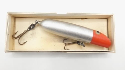 A scarce Hardy Darting and Diving 5" sea bait, the wooden plug shaped lure painted red/silver decoration, with twin glass eyes and rear swivel mounted treble hook on original card mount and in white card trade box