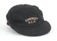 Ian Terence Botham. Somerset, Worcestershire, Durham, Queensland & England 1974-1993. Somerset Schools Cricket Association cricket cap worn by Botham. The black cloth cap with red band to the lower edge of the back of the cap, with ‘Somerset S.C.A.’ embro