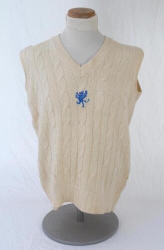 Ian Botham. Somerset 2nd XI sleeveless sweater issued to and worn by Botham in his early playing career. The woollen sweater with emblem of mid blue dragon and red tongue to chest. Maker unknown. Slight staining to reverse, otherwise in very good conditio