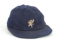 Ian Botham. Somerset 1st XI cricket cap worn by Botham during his playing career with the county. The blue cloth cap, by Foster of London, with the Somerset emblem of a dragon embroidered in white and a touch of red to the front. The cap with wear interna