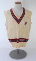 Ian Botham. Somerset Ist XI sleeveless sweater issued to and worn by Botham in his early playing career. The cream woollen sweater by ‘Morrant Sports’ with county colours of maroon, grey and black to neck and waist and emblem of maroon dragon and red tong