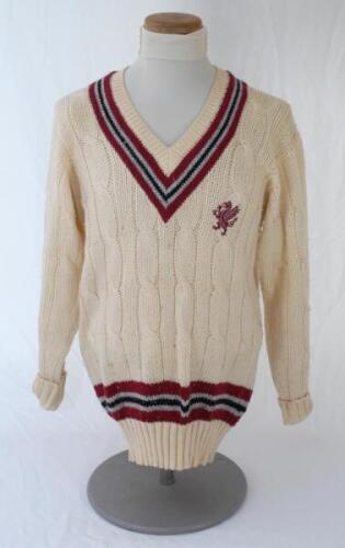 Ian Botham. Somerset Ist XI long sleeve sweater issued to and worn by Botham in his playing career. The cream woollen sweater by ‘Morrant Sports’ with county colours of maroon, grey and black to neck and waist and emblem of maroon dragon and red tongue. V