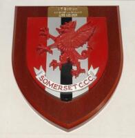 Ian Botham. ‘Life Member- Somerset County Cricket Club’. A large wooden plaque presented to Ian Botham on becoming a life member at the club. The plaque with Somerset emblem of the dragon in club colours of red, white and black with small plaque to the to