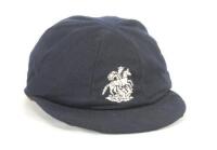 Ian Botham. M.C.C./England navy blue touring cap, by Michael of Chatham, worn by Botham during his Test playing career touring with England. The cap, with embroidered England emblem of St. George and the Dragon to front. Minor wear to the edge of the pea