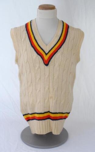 Ian Botham. England 1980s. Original M.C.C. touring sleeveless woollen sweater worn by Botham during his playing career. The sweater with M.C.C. colours to neck and waist. ‘Ian Botham’ cloth name tag to inside collar. Maker unknown. Minor stain to front, t