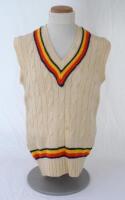 Ian Botham. England 1980s. Original M.C.C. touring sleeveless woollen sweater worn by Botham during his playing career. The sweater with M.C.C. colours to neck and waist. ‘Ian Botham’ cloth name tag to inside collar. Maker unknown. Minor stain to front, t