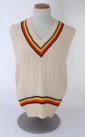 Ian Botham. England 1980s. Original M.C.C. touring sleeveless woollen sweater worn by Botham during his playing career. The sweater with M.C.C. colours to neck and waist. Bill Edwards of Swansea. Very good condition.