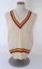 Ian Botham. England 1980s. Original M.C.C. touring sleeveless woollen sweater worn by Botham during his playing career. The sweater with M.C.C. colours to neck and waist. Bill Edwards of Swansea. Very good condition.