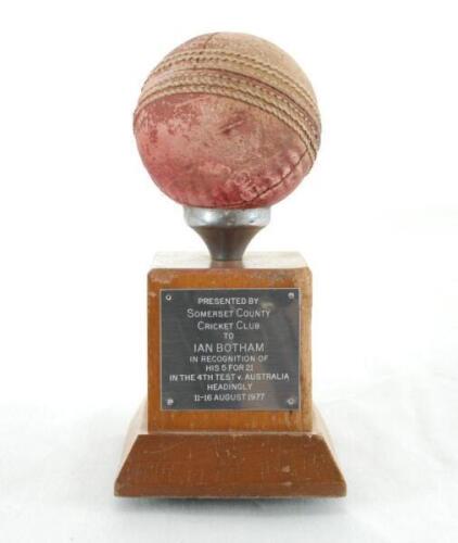 Ian Botham. Original cricket ball presented to Botham having taken five wickets for 21 runs for England v Australia at Headingley in August 1977. The ball is mounted on wooden plinth block with silver metal plate to side which reads &lsquo;Presented by Somerset
