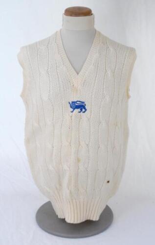 Ian Botham. England 1980s. Original England one day international woollen sleeveless sweater worn by Botham during his playing career. The sweater by Simpson of Piccadilly with single blue lion emblem to chest. Small scorch mark to front, otherwise in ver