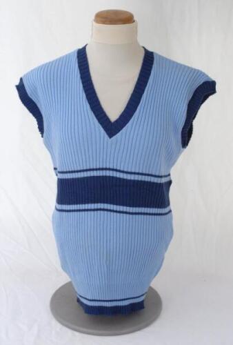 Ian Botham. England. Benson & Hedges World Series Cup 1986/87. Original pale blue England sleeveless sweater, short sleeve shirt and trousers, match worn by Botham. The sweater by Rainbow Knitwear and the shirt by Veltex both with dark blue trim, the trou