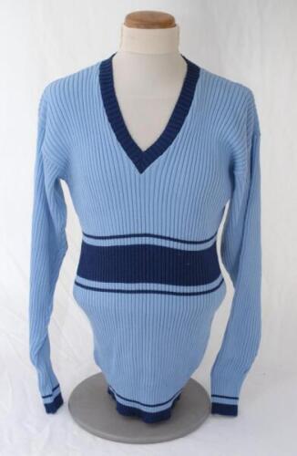 Ian Botham. England. Benson & Hedges World Series Cup 1986/87. Original pale blue England long sleeve sweater, short sleeve shirt and trousers, match worn by Botham. The sweater by Rainbow Knitwear and the shirt by Veltex both with dark blue trim, the tro