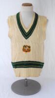 Dennis Lillee. Western Australia & Australia 1969-1988. Original Australia woollen sleeveless sweater worn by Lillee during his playing career, probably 1980s. The sweater with Australia colours of green and gold to neck and waist, Australia shield emblem