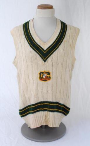 Merv Hughes. Victoria & Australia 1981-1995. Original Australia woollen sleeveless sweater worn by Hughes during his playing career, probably late 1980s. The sweater with Australia colours of green and gold to neck and waist, Australia shield emblem to ch