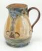 Doulton Lambeth stoneware jug, of bulbous form, moulded with relief vignettes of cricketers, a batsman, bowler and wicket keeper, Abel, Woods and McGregor in white on a brown background. With stylised floral leaf and flower Art Nouveau decoration to top a