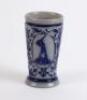 Westerwald stoneware cricket beaker, moulded in relief with three cameo panels of a batsman, after W.G. Grace, in different poses. The body decorated with vine and sprig decoration in cobalt blue on a grey background. Blue rings to rim and to foot. Approx - 2