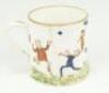 Cricket mug. Small Victorian Staffordshire ceramic mug printed in colour with amusing scenes of ladies and gentlemen playing cricket, the ladies wearing fashionable dresses and all carrying parasols, one gentlemen in top hat, two gentleman attempting to c - 2