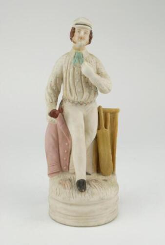 Continental cricket figure. Early bisque cricketing figure of an early bowler on naturalistic base, wearing a white cap, blue spotted shirt with light blue tie, white trousers, colourful sash, standing with a pink blazer to one side and wicket and bat to 