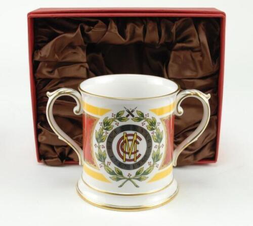 M.C.C. Bicentenary 1787-1987. Spode china two handled loving tankard with decoration and titles to front and back, gold lustre to handles, rim, and base. 4.5” tall. In presentation box as issued. Sold with a commemorative bronze metal medal in original pr