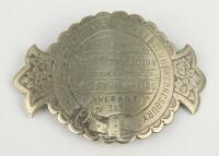 Cricket belt buckle. A large curved Victorian heavily decorated silver belt buckle awarded to John Dorrinton in 1878 for best bowling average. The buckle circular with additional side extensions bearing floral designs. To centre the buckle is inscribed ‘P