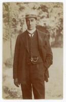 Frank Laver. Victoria & Australia 1891-1912. Original sepia real photograph postcard of Laver, three quarter length, wearing suit and straw boater with Australian emblem to the hat band, probably on the 1905 tour to England. Nicely signed in pencil to the