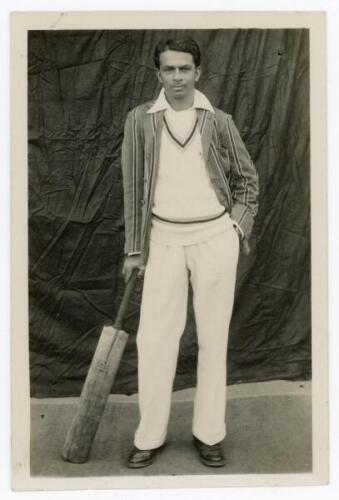 Naoomal Jaoomal Makhija. Northern India, Hindus, Sind & India 1926-1945. Rare mono real photograph postcard of Naoomal standing full length leaning on a bat, wearing cricket attire and striped blazer. Published by Johnny Stores, Camp-Karachi. Postally unu