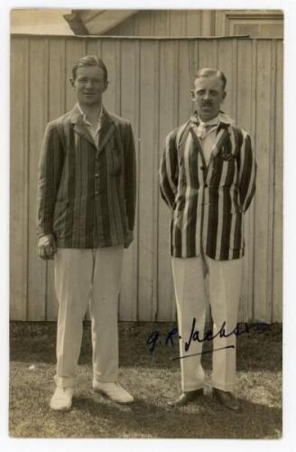 Guy Rolfe Jackson. Derbyshire 1919-1936. Sepia real photograph postcard of Jackson standing full length with B.S.H. Hill-Wood (Derbyshire 1919-1925), both wearing cricket attire and striped blazers. Nicely signed in black ink to the photograph by Jackson.