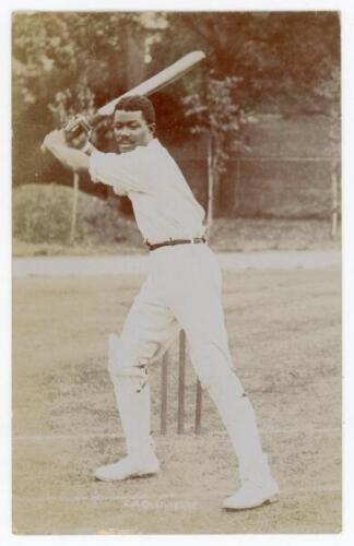 Charles Augustus Ollivierre. Trinidad & Derbyshire 1894-1907. Rare and early sepia real photograph postcard of Ollivierre full length at the wicket in batting pose. Publisher unknown, appears to be Foster or Hawkins. Postally unused. Slight fading to the 