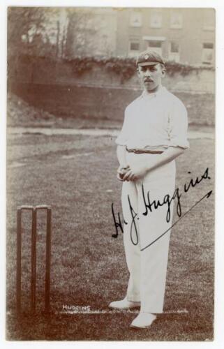 Henry James Huggins. Gloucestershire 1901-1921. Early sepia real photograph postcard of Huggins standing full length at the crease, ball in hand, wearing cricket attire and cap. Beautifully signed in black ink to the photograph. Foster of Brighton. Postal