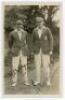 A.E.R. Gilligan (Cambridge University, Surrey, Sussex & England 1919-1932) and Maurice William Tate (Sussex & England 1912-1937). Excellent original sepia real photograph postcard of Gilligan and Tate standing together full length wearing cricket attire a