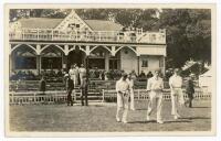 Sussex C.C.C. 1909. Excellent early original mono real photograph postcard of the Sussex captain, C.L.A. Smith, leading his team on to the field from the attractive pavilion at The Saffrons, Eastbourne in 1909. A sprinkling of spectators seated on the pav