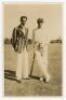 Worcestershire c.1935. Original sepia real photograph postcard of the Nawab of Pataudi and Cyril Walters standing full length together on the outfield, Pataudi wearing a striped blazer, Walters in batting attire and England cap, leaning on his bat. Publis