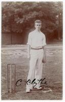 Colin Blythe, Kent & England 1899-1914. Excellent sepia real photograph postcard of a youthful Blythe, full length, in batting attire, wearing England touring cap stood in front of the wicket holding a cricket ball. The postcard very nicely signed to imag