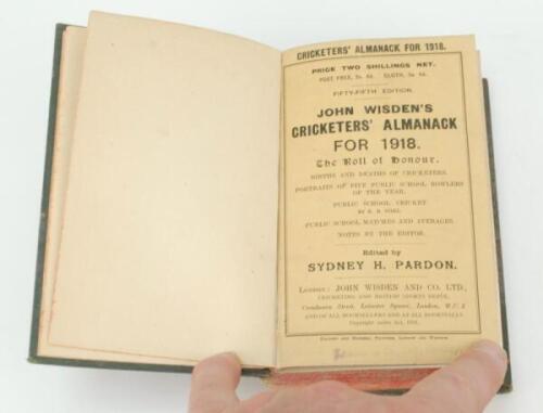 Wisden Cricketers’ Almanack 1918 and 1919. 55th and 56th editions. Original paper wrappers, the two volumes bound together in green boards with title and date to spine in gilt, red speckled page edges. Wear with loss to the base of the spine, very heavy d