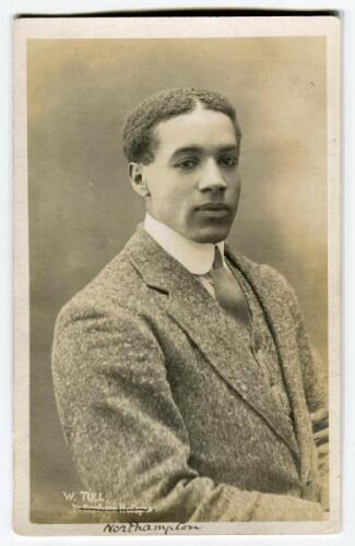 Walter Daniel John Tull. Tottenham Hotspur 1908-1911. Mono real photograph postcard of Tull, hal length wearing three piece suit and tie. F.W. Jones of Tottenham. The word Tottenham Hotspur has been crossed through and Northampton (his next club) written 