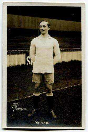 Charles Wilson. Tottenham Hotspur 1918-1923. Mono real photograph postcard of Wilson, full length, in Spurs attire in front of the main stand. W.J. Crawford of Edmonton to face of card. Postally unused. Good/very good condition.