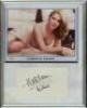 Kathleen Turner. American film actress. Signature of Turner on white card, mounted below colour image of Turner, framed. Overall 8.25”x10.5”. G.