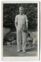 Constantine ‘Gene’ Mako. Original mono real photograph postcard of Mako, standing full length, wearing tennis attire and holding two rackets to his side. Players name printed to lower border. Card no. T13 in a series issued by Edwin Trim & Co. of Wimbledo